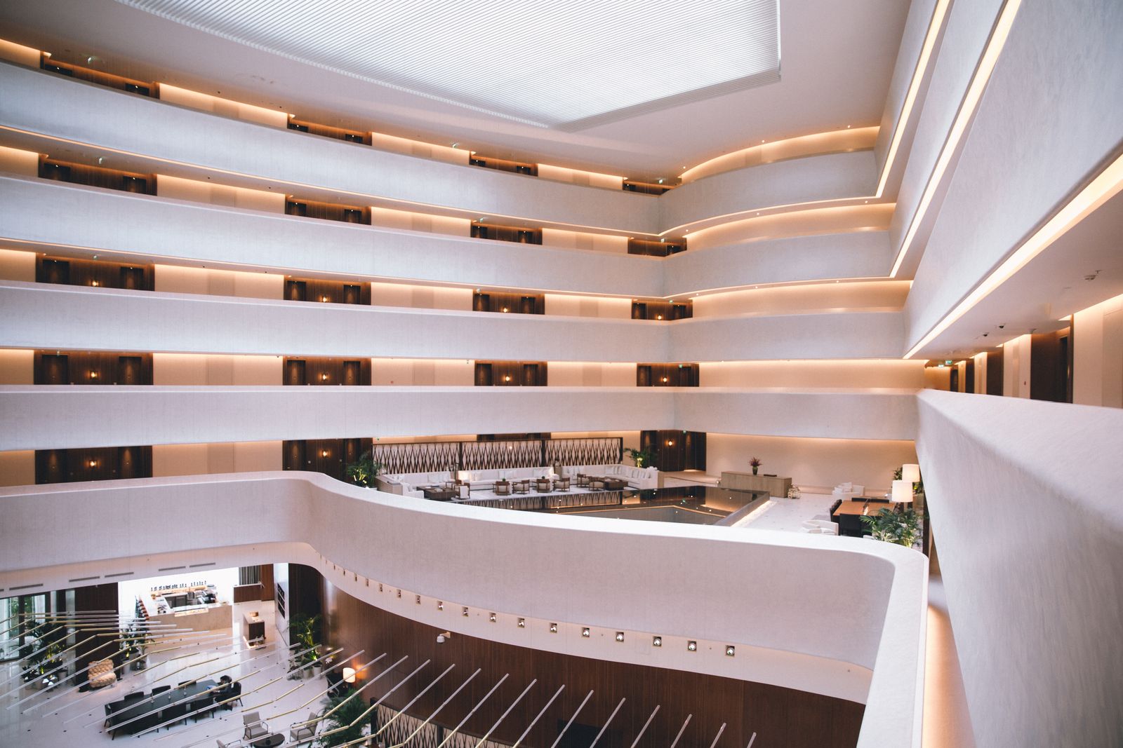 Hotel atrium with tiered balconies and warm lighting