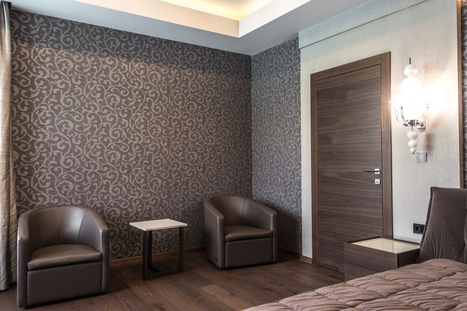 Finished hotel bedroom with seating area